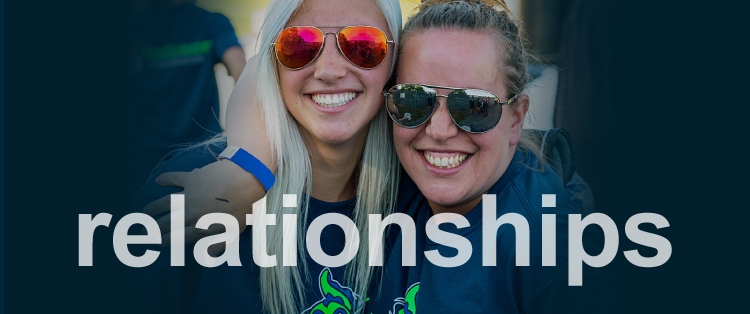 two women smiling and wearing sun glasses